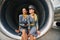 Two pretty stewardesses in uniforms sitting in the aeroengine