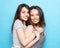 Two pretty teen girlfriends smiling hugs and having fun