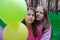 two pretty teenage girls friends with colorful balloons in park. happy kids. summer days. vacation, holidays. friendship