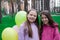 two pretty teenage girls friends with colorful balloons in park. happy kids. summer days. vacation, holidays. friendship