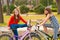 Two pretty teenage girls having fun on bicycles