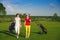 Two pretty women golfers walking at golf course