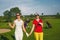 Two pretty women golfers walking at golf course