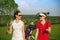 Two pretty women golfers walking at golf course