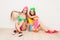 Two pretty young women siting on floor with skate