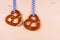 Two pretzel in heart shape on wood background