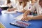 Two primary school kids working in class, close crop