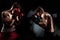 Two professional boxer boxing on black smoky background,