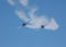 Two propeller airplanes trailing smoke and diving in a simulated attack