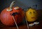 Two pumpkins faces Halloween decorations wooden background