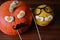 Two pumpkins faces Halloween decorations wooden background