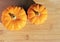 Two pumpkins on a textured wooden background. Fall concept with copy space