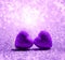 Two purple Hearts on abstract light glitter background