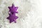 Two purple star baubles