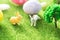 Two rabbit toys with easter eggs on a meadow grass. Yellow easter egg spring meadow with two rabbit and easter eggs. Fairy tale