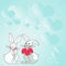 Two rabbits with heart shaped gifts with heartful background demonstrate couples exchanging offerings. Bunnies represent