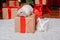 Two rabbits, a white albino and a lop-eared one, are sitting on the background of a Christmas tree