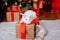 Two rabbits, a white albino and a lop-eared one, are sitting on the background of a Christmas tree