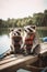 Two raccoons sitting on a dock next to a body of water. Generative AI image.