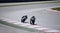 Two racers on a motorcycles rides on the speed of the track