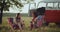 Two racial friends man and woman have a picnic time sitting in the middle of nature, with amazing view drinking wine and