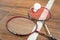 Two rackets and shuttlecock lying on badminton court