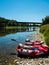 Two rafting boats with paddles laying on shore of beautiful natural river