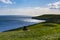 Two ramblers take a rest on a bench above Dancing Ledge