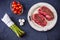 Two raw filet steaks with green asparagus, mushrooms