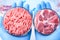 Two raw meat samples one whole one ground in laboratory Petri dishes in scientist hands