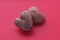 Two raw potatoes in the shape of a heart together on a red background. Potato love story. history 3. Pink potatoes