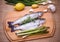 Two raw trout with green asparagus, lemon and garlic