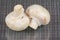 Two raw white champignons