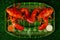 Two ready to eat lobsters with ball and dipping sauce on green plate