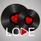 Two Realistic Black Vinyl Records with red heart labels, word love and play button. Retro Sound Carrier on gray background