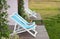 Two Recline chairs on dock facing a green lake.