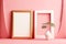 Two rectangular picture frame mockups against light pink wall