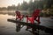 Two red adirondack chairs on a wooden dock on a lake. Generative AI