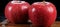 Two red apples sitting on top of a wooden cutting board. Generative AI image.