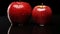 two red apples with water droplets on them