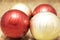 Two red balls next to two golden balls for Christmas decorations
