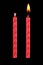 two red birthday candles isolated on black