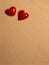 Two red ceramic hearts on love letter paper background