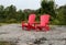 Two red chairs on a granite hill