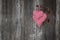 Two red checkered heart shape hanging on rusty door handle for v