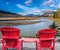 Two red comfortable loungers by the lake