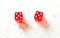 Two red craps dices showing Hard Ten double number five overhead shot on white board