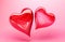 Two red crystal hearts on pink background. Valentine\\\'s day love mother\\\'s day concept. Template with copy space