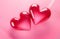 Two red crystal hearts on pink background. Valentine\\\'s day love mother\\\'s day concept. Template with copy space