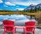 Two red  deck chairs on the lake